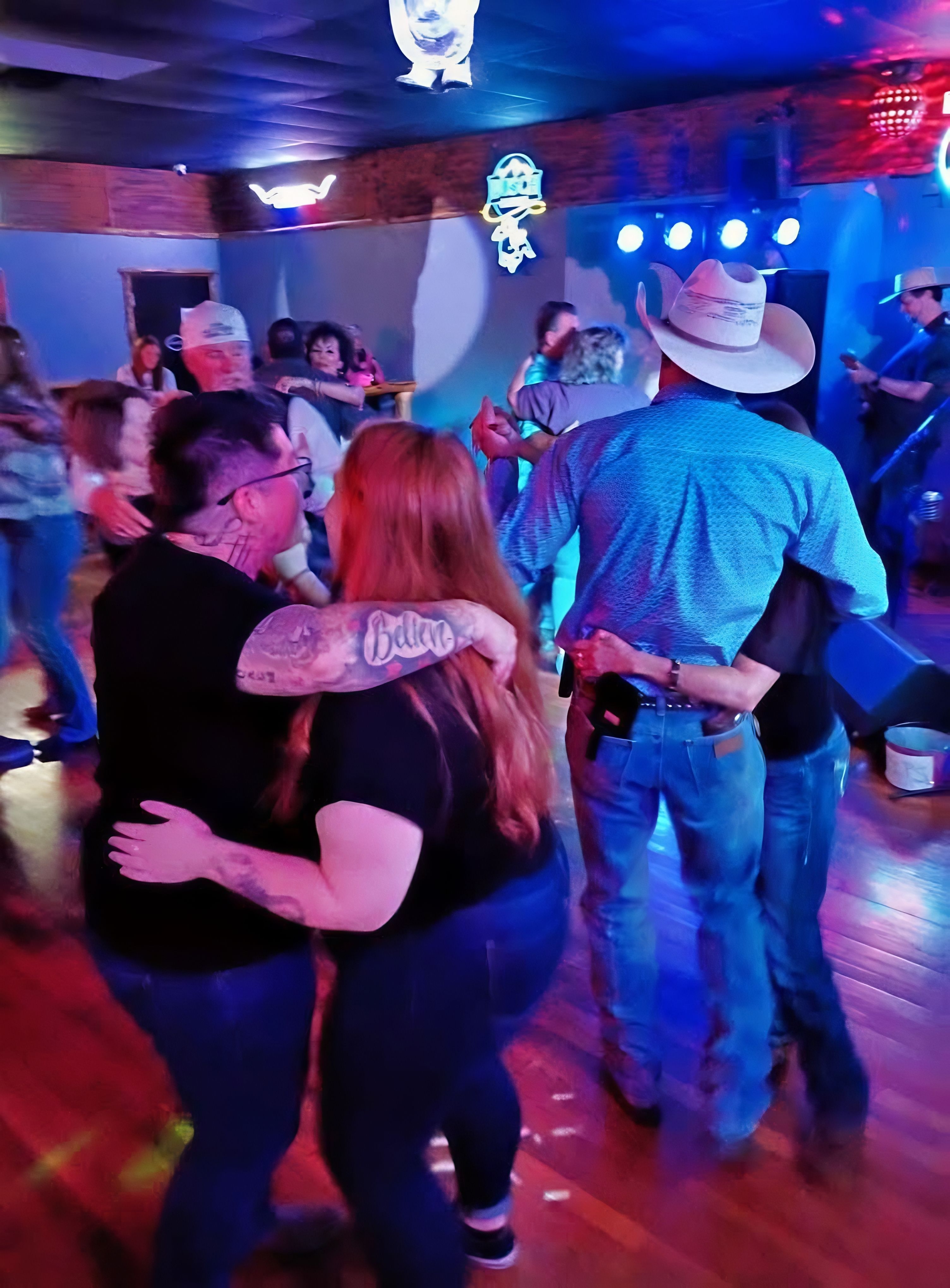 Couples two-stepping on the dance floor at Crazy Horse Saloon
