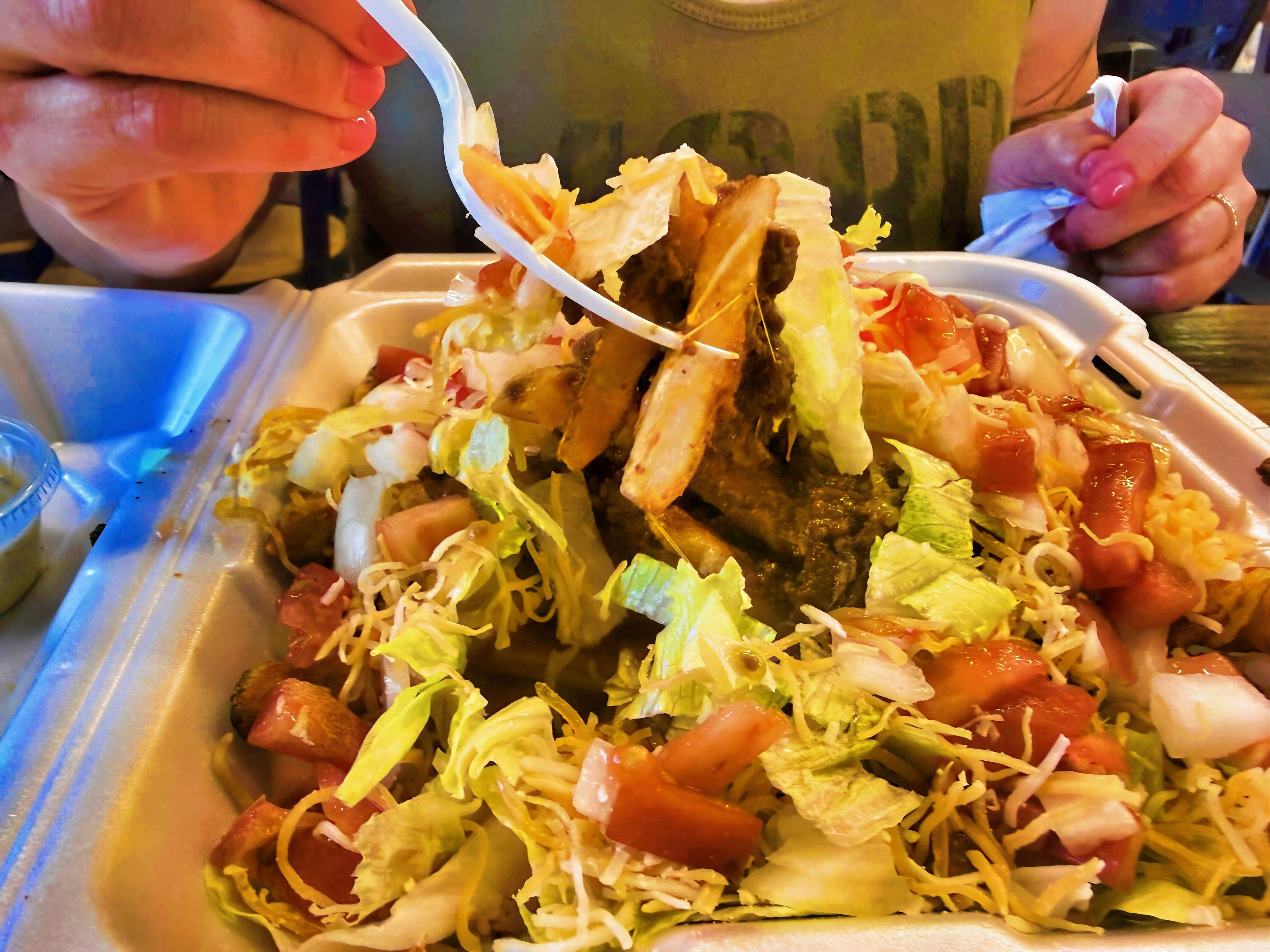 Loaded Fries with chili, cheese, lettuce, tomatoes, onion and jalapeños