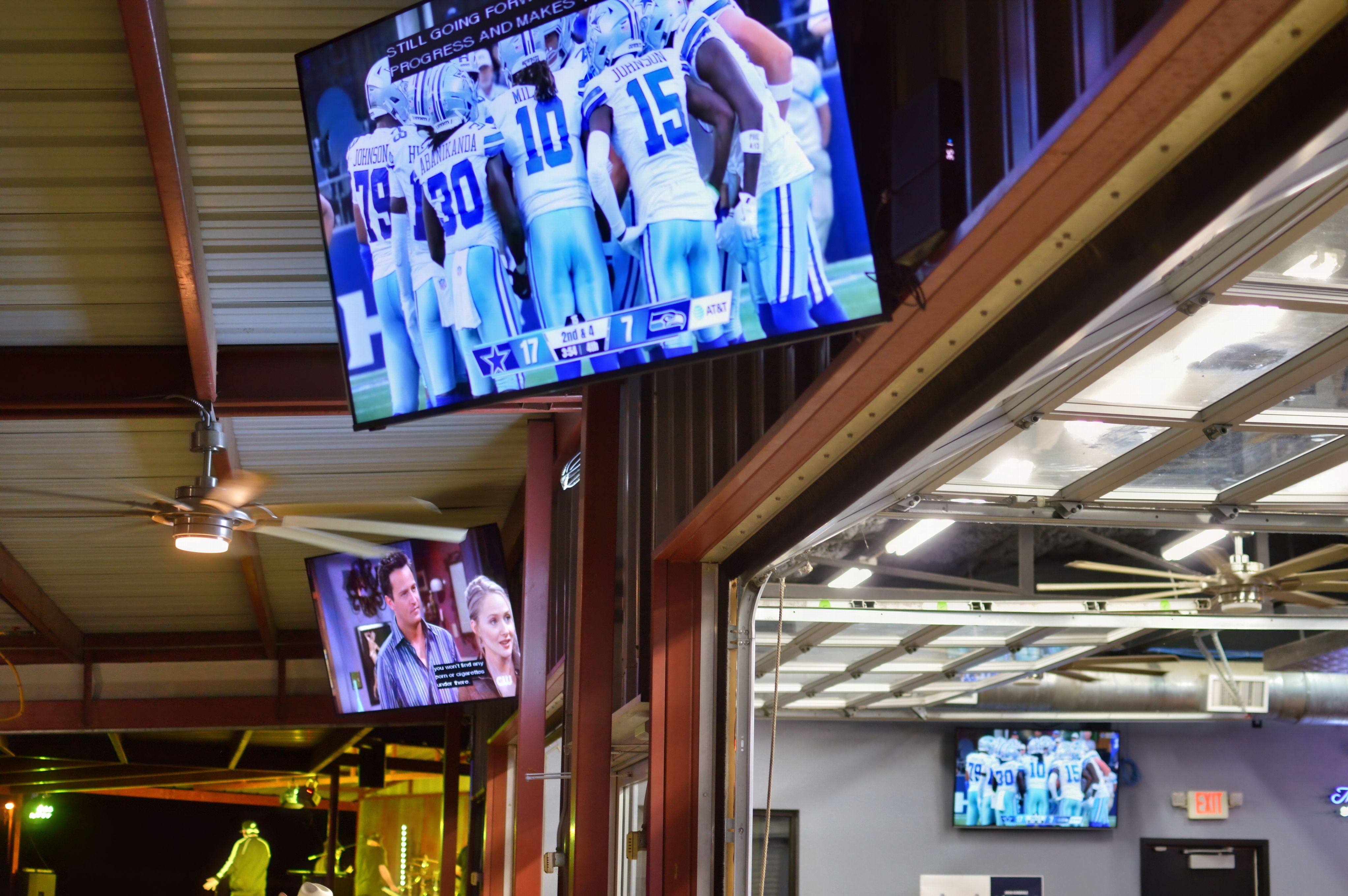 TVs throughout the front bar, back bar, and outdoor seating at Crazy Horse Saloon
